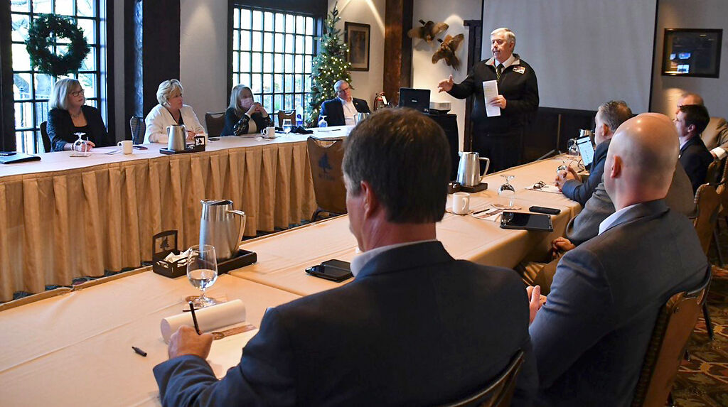 Gov. Mike Parson speaks to massless lawmakers at a retreat
